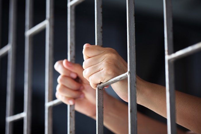 Stock image, woman behind bars